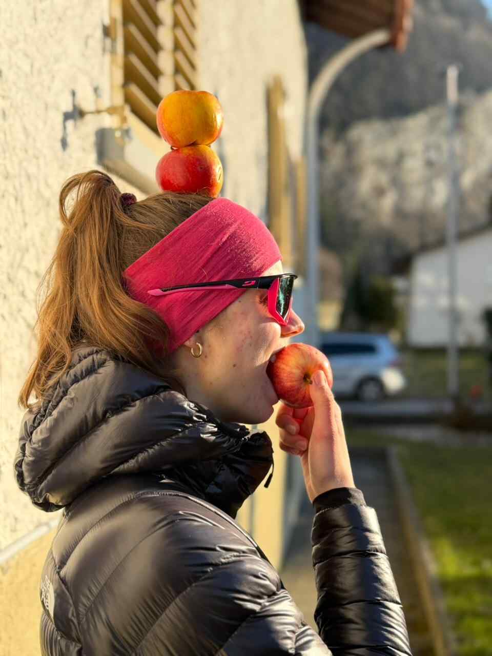 Allergikerfreundliche Apfelsorte "Pompur" nun erhältlich. Praktikantin Victoria beißt genüsslich in einen Apfel und hat zwei davon am Kopf